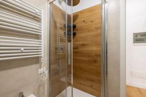 una doccia con una porta in vetro in un bagno di Little House 15 a Roma Altre 7 foto