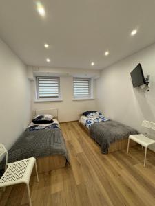 En eller flere senge i et værelse på Lokietka