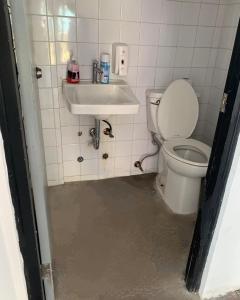 a bathroom with a toilet and a sink at Casa Vintage in Panama City
