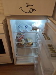 an open refrigerator filled with food and drinks at Stella Marina in Giardini Naxos