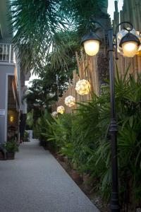 a street light next to a sidewalk with plants at MJ Boutique Hotel Khao Lak in Khao Lak