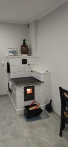 a white brick fireplace in a living room at Agroturystyka nad Brusieńką in Cieszanów