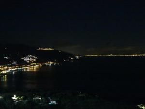a view of the water at night at Villa Astoria in Taormina