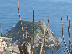 a view of a beach with a rock and the ocean at Villa Astoria in Taormina