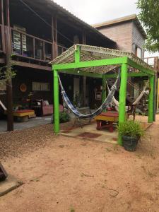 a hammock in a pavilion outside of a building at Las Alqui millas Apart in Punta Del Diablo