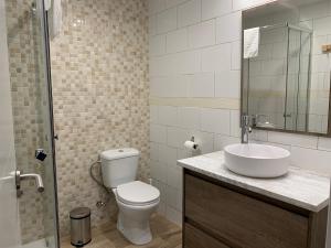 a bathroom with a toilet and a sink and a shower at Casa Lina in Barcina del Barco
