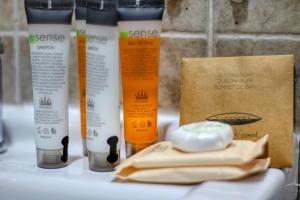 a group of four bottles of beauty products on a counter at 2 Hidden Gems - all U need - by Uni88 in Bucharest +24 photos