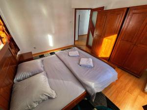 a large bed in a bedroom with two pillows on it at Casa Kolbert in Borsec +29 photos