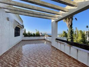 an outdoor patio with a view of the ocean at Villa familiale Achakkar 2 in Tangier