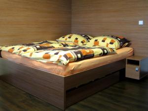 a bed with pillows on it in a bedroom at Apartmány na Dolní Moravě in Dolní Morava