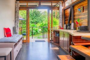 a kitchen with a large open door to a patio at Arenal Getaway in Fortuna