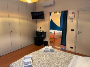 a room with a bedroom with a bed and a mirror at Bracco Rooms & Suites - Boutique Hotel nel Centro Storico di Matera in Matera