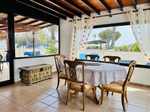 a dining room with a table and chairs at Villa Sol Nudist Place in Charco del Palo
