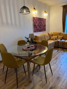 a living room with a table and chairs and a couch at Pastelowa Czantoria in Ustroń