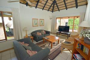 a living room with a couch and a table at Kruger Park Lodge - Unit 522 , Hazyview in Hazyview