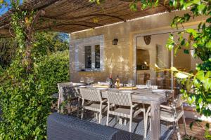 een patio met een tafel en stoelen bij Villa Beauregard by Villa Plus in Tourrettes