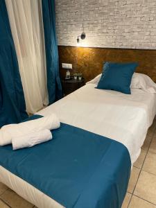 Postel nebo postele na pokoji v ubytování HOTEL ORENETA - Gironella