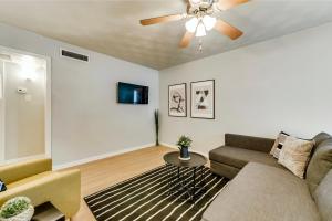 a living room with a couch and a ceiling fan at Global Cup Insta-Worthy Flat and Arboretum Tickets Included in Dallas