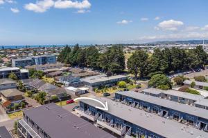 an aerial view of a town with buildings at Golden Retreat, Central Mount Maunganui in Mount Maunganui