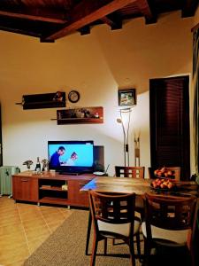 a living room with a wooden table and a television at Pirin Golf hotel, Apartment Chalet style in Razlog +20 photos