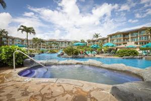 a pool at a resort with a hot tub at Waipouli Beach Resort and Spa Kauai by OUTRIGGER in Kapaa