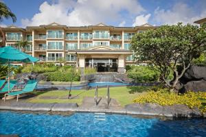 a hotel with a swimming pool and a resort at Waipouli Beach Resort and Spa Kauai by OUTRIGGER in Kapaa +18 photos