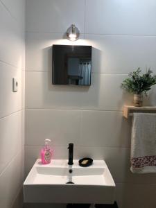 a bathroom with a white sink and a mirror at Covo Residence - Casa Manhusca in Vila Cova-à-Coelheira +10 photos