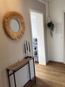 a room with a mirror on the wall and a table at Familienfreundliche FEWO in bester Lage in Offenburg