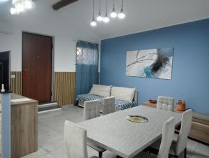 a dining room and living room with a table and chairs at Blu Etna Casa Vacanze in Zafferana Etnea