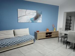 a bedroom with a bed and a table and a desk at Blu Etna Casa Vacanze in Zafferana Etnea +67 photos