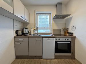 a small kitchen with a sink and a stove at Riva in Überlingen