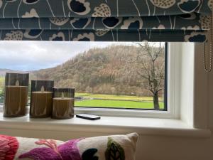 a window with a view of a mountain at The Shepherd's Nook in Thirlmere