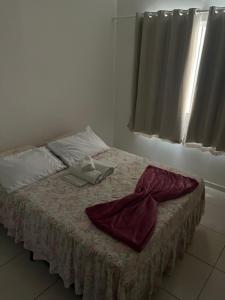 a bed in a white room with a blanket on it at Pé na areia in Ilhéus +12 photos