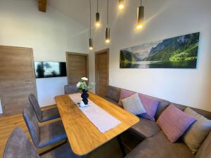 a dining room with a table and a couch at Ferienwohnung Plechau in Russbach am Pass Gschütt