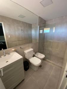 a bathroom with a toilet and a sink at Complejo Chaya in La Rioja