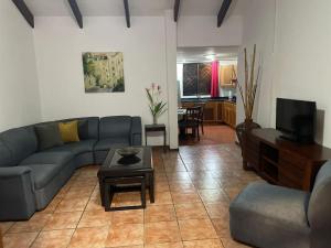 a living room with a couch and a table at Sea view Apartment in Puerto Limón