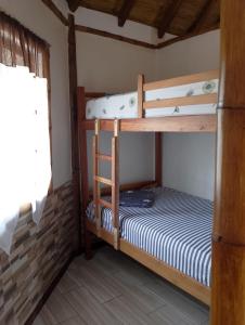 a bedroom with two bunk beds in a house at Cabañas Riviera Pacific in Pedernales