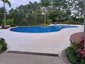 una piscina in un cortile con patio di Hospedaje cómodo con oficina a Heredia