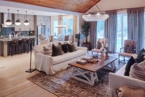 a living room with a white couch and a table at The Rookery in Blackbanks
