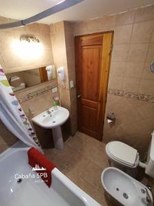 a bathroom with a sink and a toilet and a tub at Don Justo in San Carlos de Bariloche +84 photos