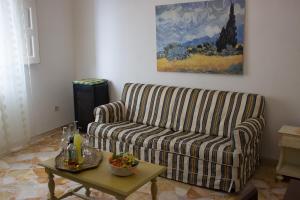 a living room with a couch and a table at Casa Macchia in Giarre