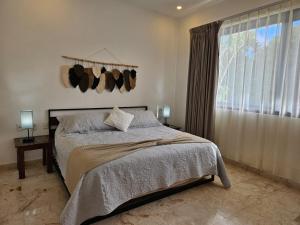 a bedroom with a bed and a large window at Villa Familiar con Alberca Privada en Tulum Country Club Riviera Maya in Akumal +62 photos