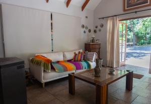 a living room with a couch and a table at Cabañas lo de Victoria in Vilches +31 photos