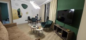 a living room with a couch and a table with chairs at Sky Lux Point in Skopje