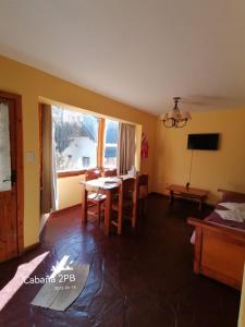 a living room with a table and a window at Don Justo in San Carlos de Bariloche