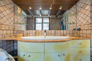 a bathroom with a sink and a mirror at Malpensa Jacuzzi House in Ferno +41 photos