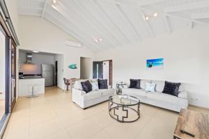 a living room with two couches and a table at SeaRenity View - Greenview 19 in Sint Michiel