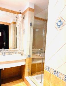 a bathroom with a shower and a sink at Domina Coral Bay Harem in Sharm El Sheikh