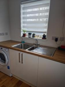 a kitchen with a sink and a window at Beolary in Oban