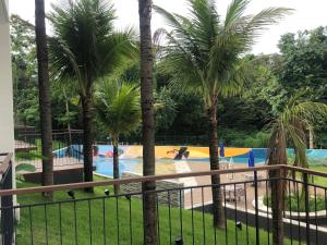 a view of a swimming pool with palm trees at Quinta de Santa Barbara Eco Resort in Pirenópolis +15 photos